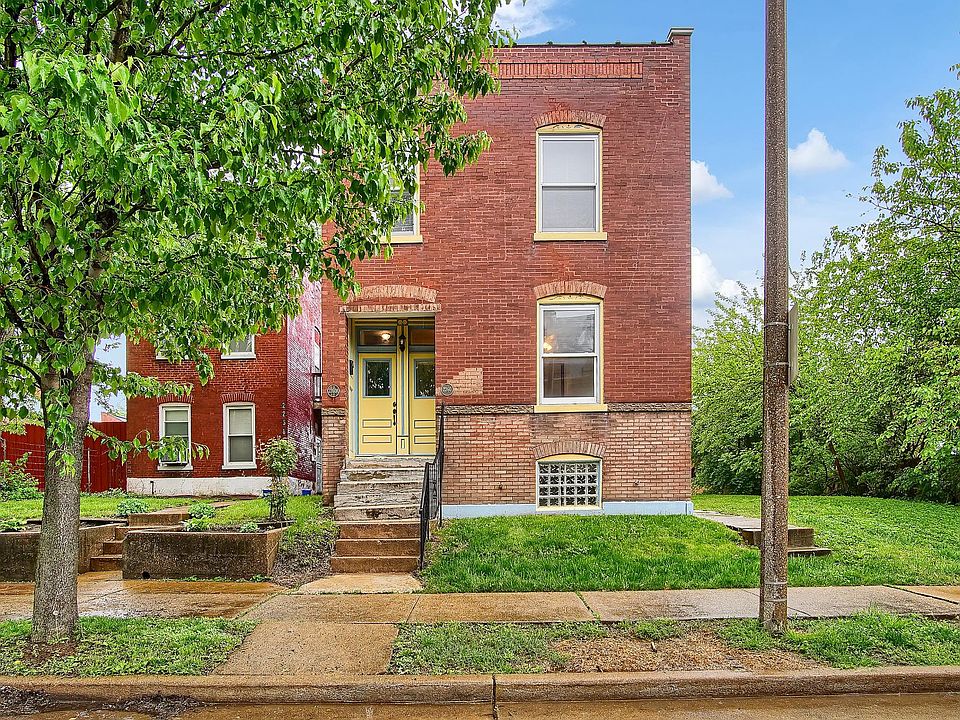 Charming brick two-family on a tree-lined street with classic curb appeal and a welcoming entry. Blending historic character with modern updates