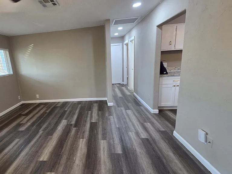 View from the living room to the kitchen and hallway to the bedrooms and bathroom
