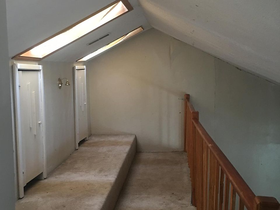 Upstairs loft/balcony area with sky lights and closets