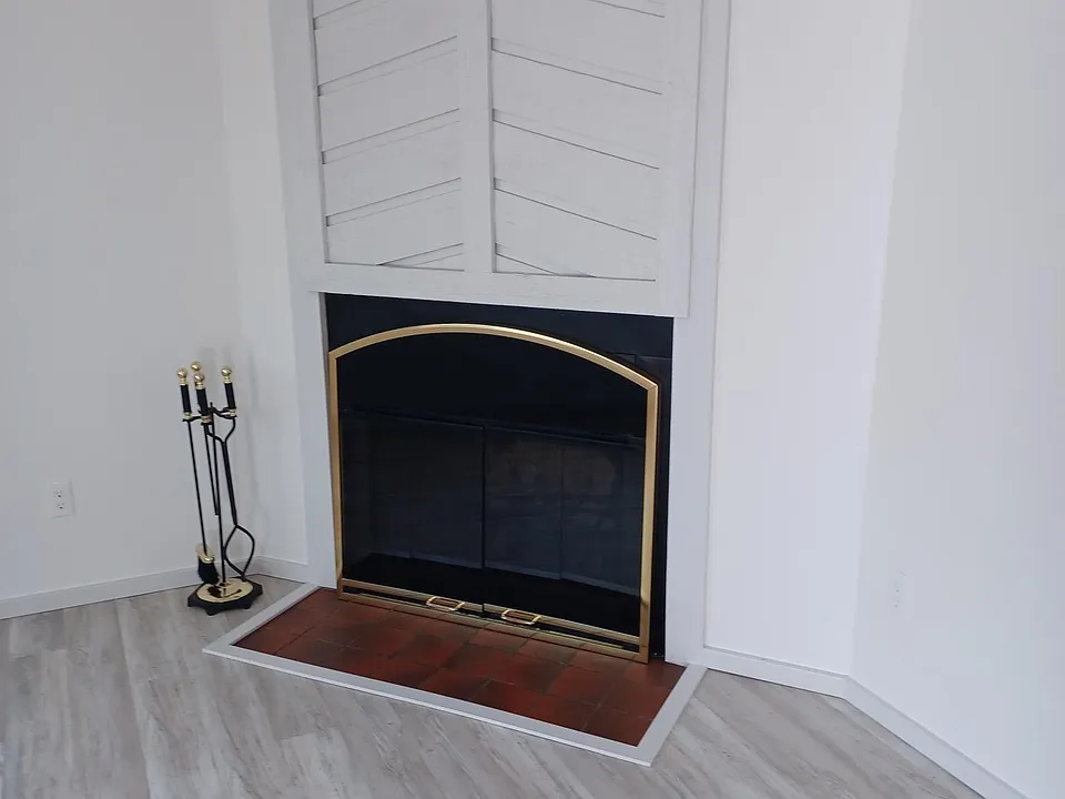 Living room fireplace shows plank easy to maintain vinyl.