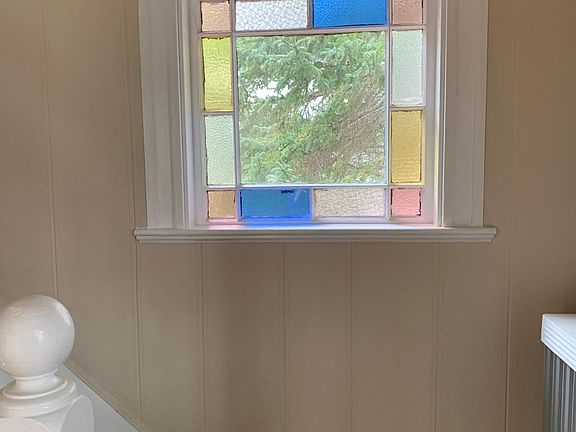 beautiful stained glass window at base of staircase