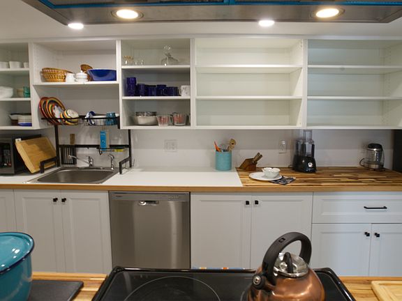 The kitchen has lots of supplies and small appliances. Fun drainboard over the sink lets water drip into sink. 
New dishwasher too.