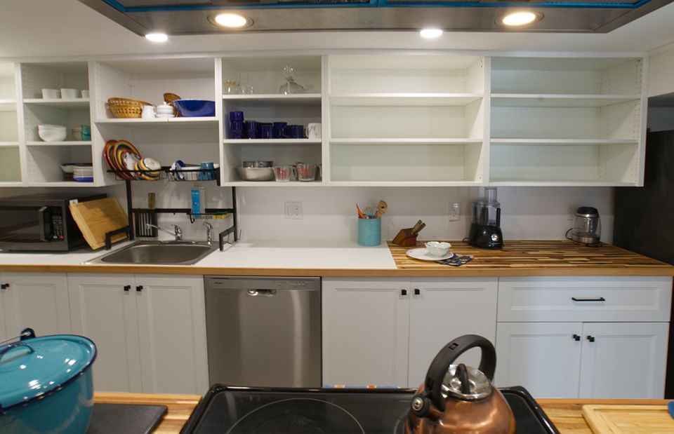 The kitchen has lots of supplies and small appliances. Fun drainboard over the sink lets water drip into sink. 
New dishwasher too.