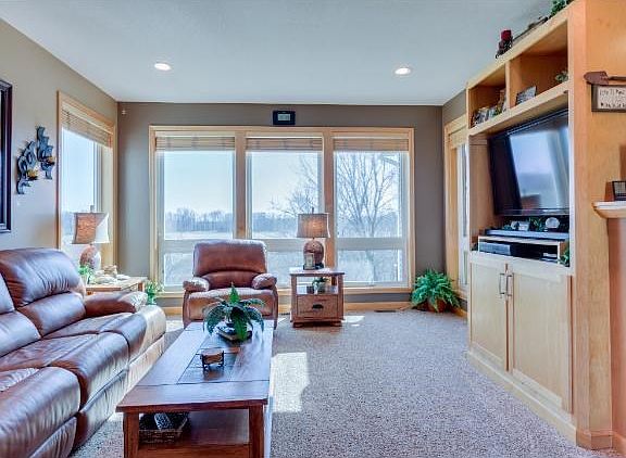 The family room has bright southern and westerly views...a great place to watch song birds, squirrels, turkey and whitetail deer. All windows feature custom window treatments, with UV protecting window tint on the main and upper levels (2014).