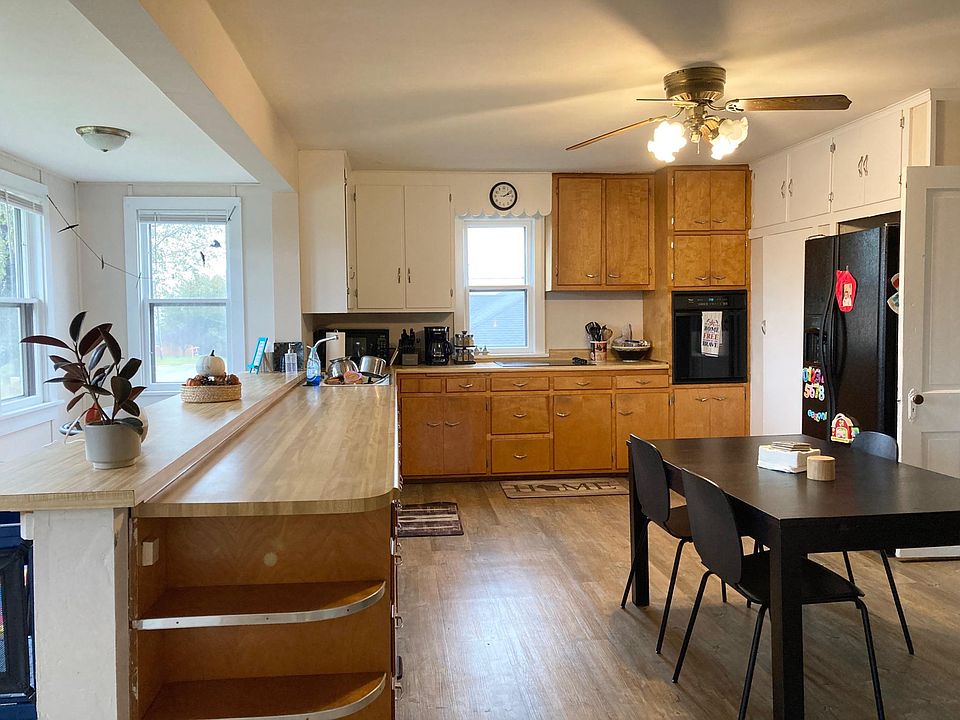 Large eat-in kitchen with bar overlooking bank of windows...lots of natural light!