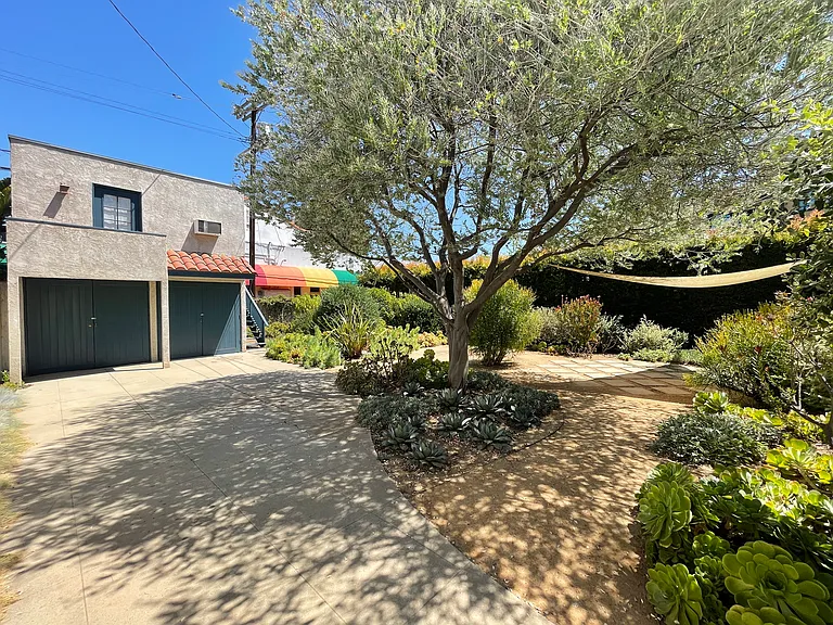 Driveway path to garden and studio above garage.