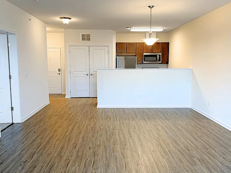 Modern, spacious living areas with luxury flooring and warm wood accents for a welcoming feel.