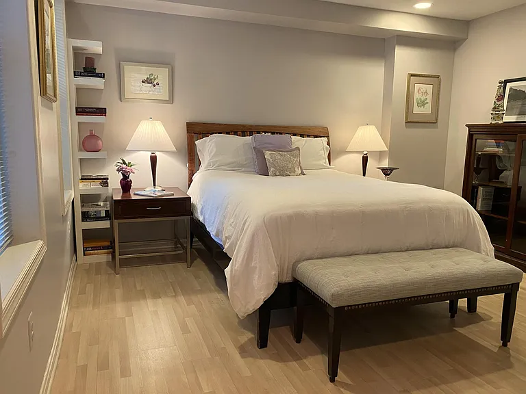 Queen bed and an attractive shelf unit with sliding glass drawers.