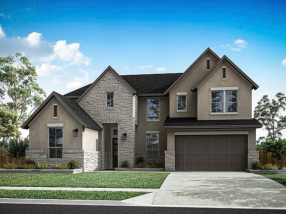 A two-story house with a stone exterior, a garage, and a well-manicured lawn set against a clear blu