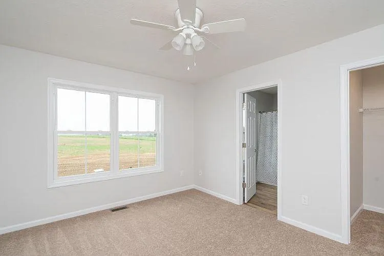 2nd floor: the master bedroom. The door on the left goes to the master bedroom's bathroom. The right side of the picture shows a partial view of the walk-in closet.