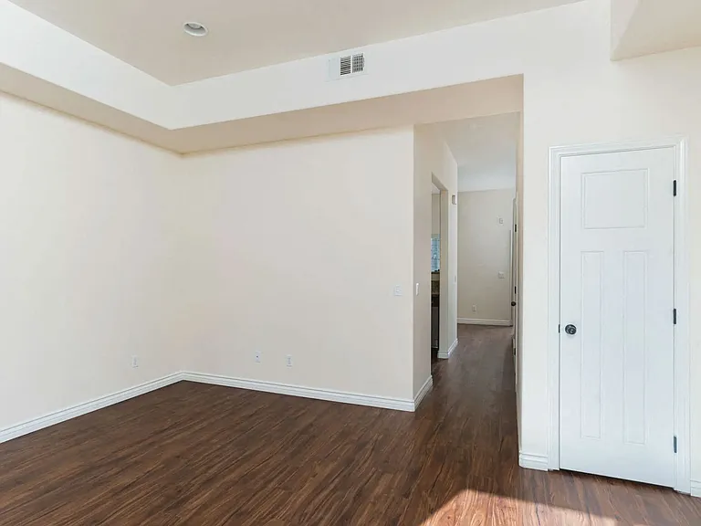 Wood style laminate flooring and high ceilings at The Nines Townhomes in Escondido, California.