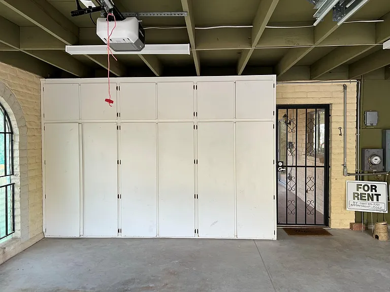 Garage storage cabinets with secure door to rear covered porch.