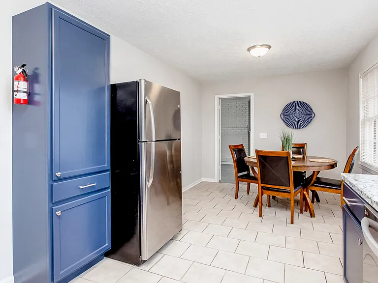 Large pantry and stainless steel fridge.