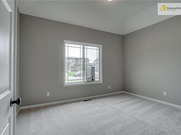 Main level guest bedroom. All bedrooms prewired for ceiling fan..