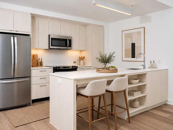 Upgraded kitchen interiors featuring a modern paint palette and French-door refrigerators