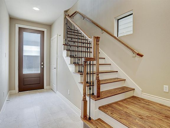 The first floor entrance has tile entrance, a closet under the stairs, and a wrought iron stair case.