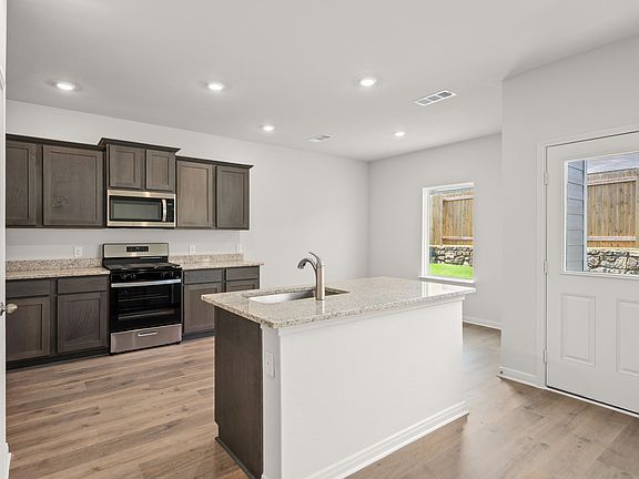 The kitchen has sprawling granite countertops.