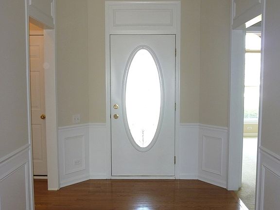 Spacious Foyer, gleaming Hardwood flooring with wainscotting and Recessed Lighting