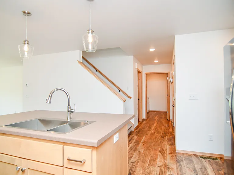 Kitchen view to back hall entrance from garage to mud room and laundry room