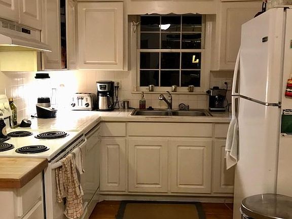 Walk in from the carport to your cozy kitchen with breakfast nook. Window looks out to natural backyard with shaded canopy.