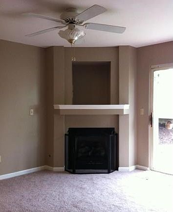 TV niche above mantel in Living Room, refurbished fireplace, new logs and unique lighted ceiling fan