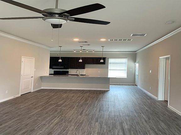 Beautiful vinyl flooring pendant lights over countertop and beautiful ceiling fan!