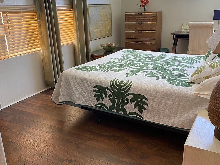 MASTER BEDROOM WITH WOOD FLOORS.