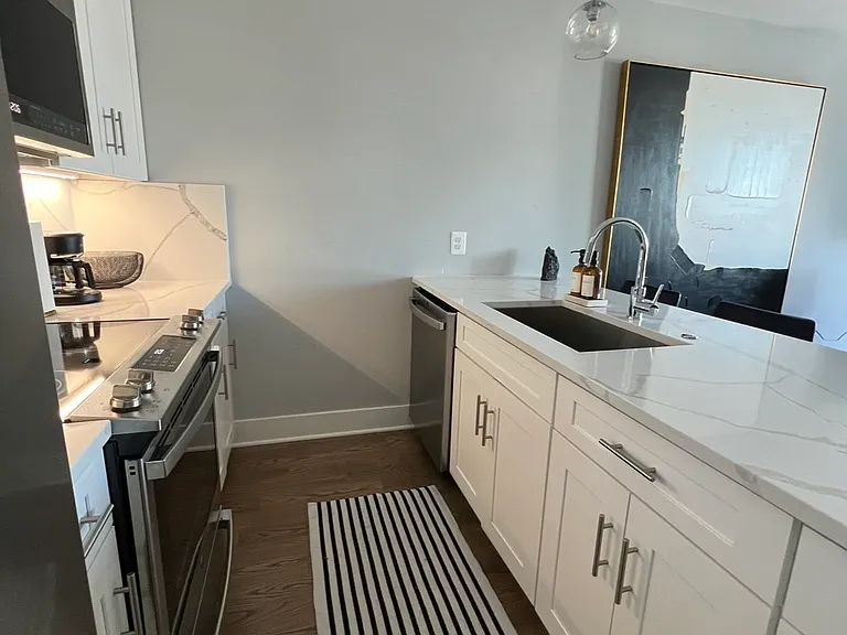 The kitchen has a full sized refridgerator, dishwasher and range stove with oven