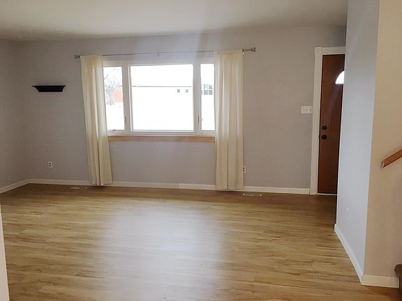 Living room, front door and large window facing west
