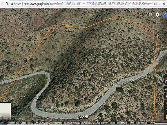 25' sloped lot & paved road