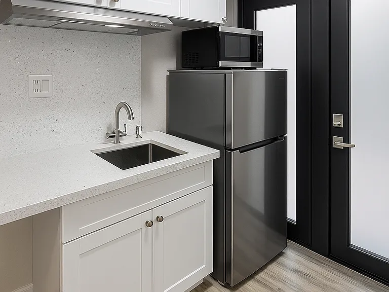 Private entrance with impact-resistant door and a stunning high-grade white quartz kitchen countertop with a sparkling finish.