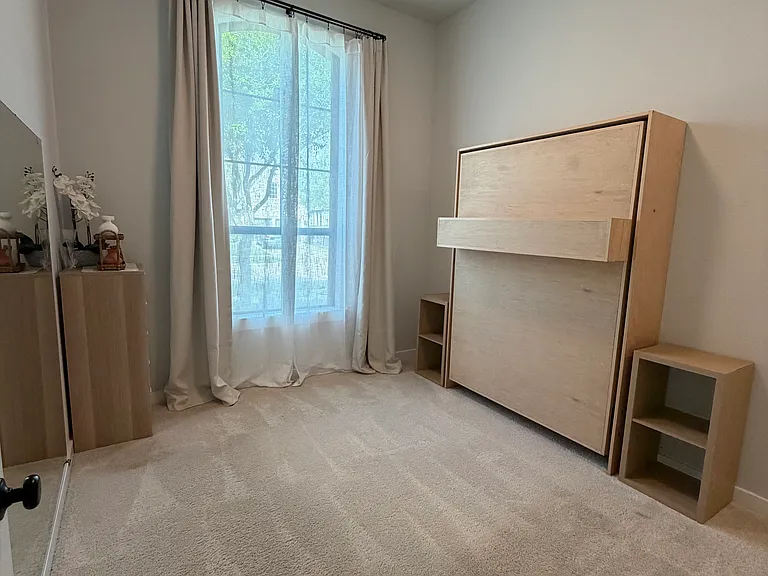 Bedroom 1. Currently has full-size murphy bed and doubles as fitness space.