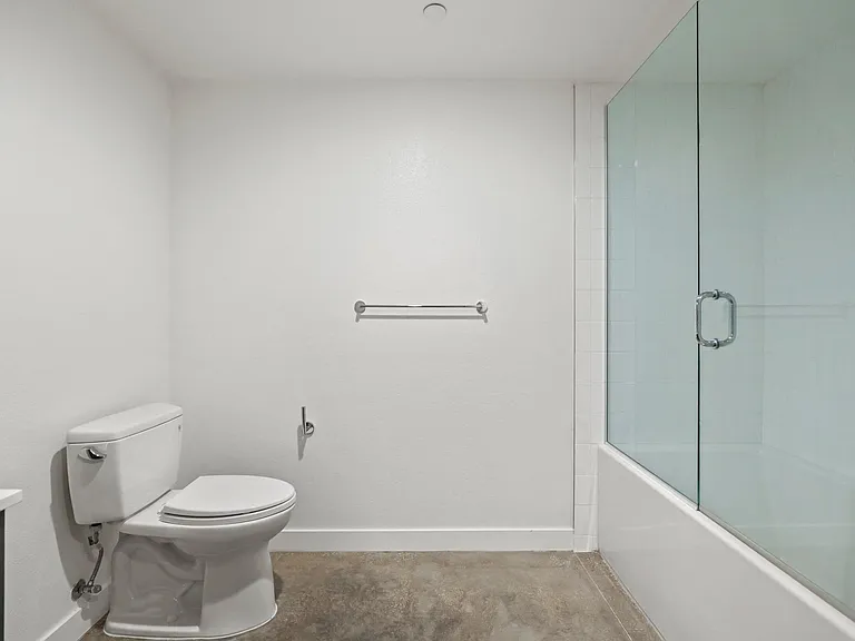 Large-Size Bathroom with a Shower Bath with Glass Door