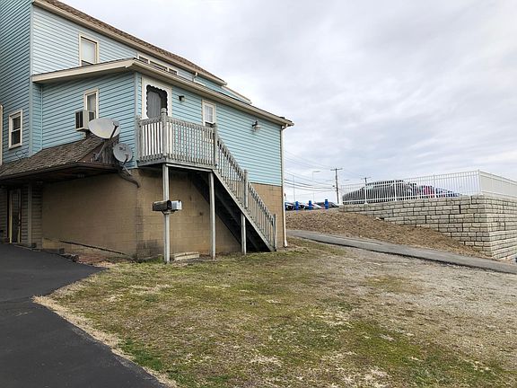 Back of building with parking area.