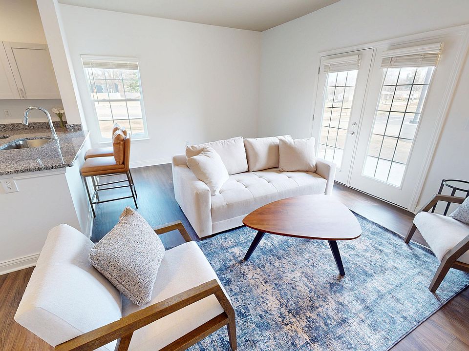 The Jane living room is spacious with double doors to the private patio/balcony.