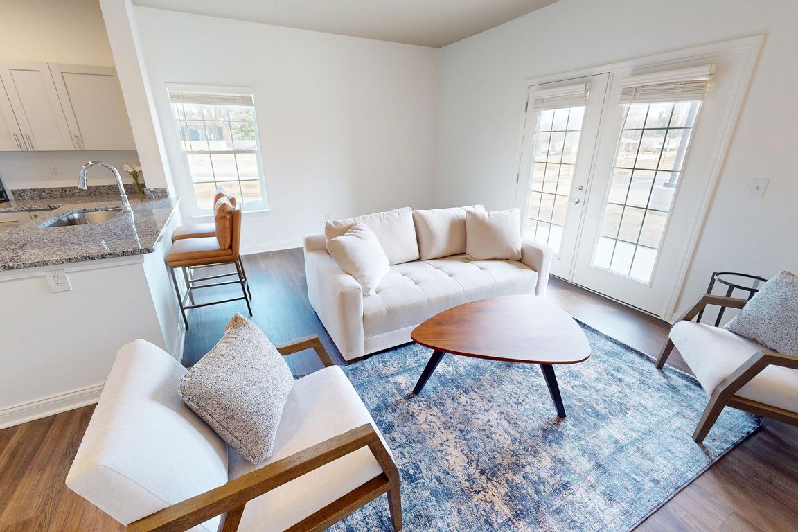 The Jane living room is spacious with double doors to the private patio/balcony.