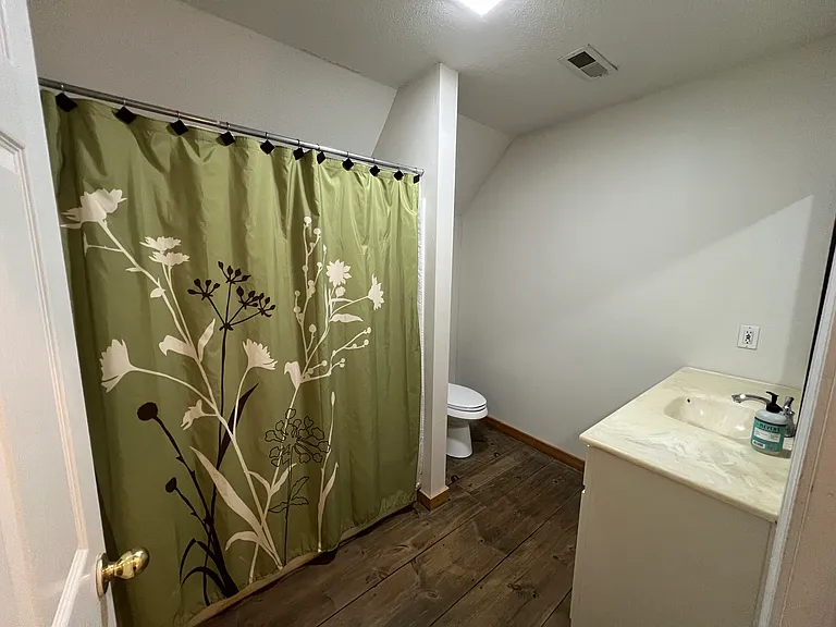 Upstairs shared bathroom. Tub/shower combo, single vanity, toilet. Storage below sink and above toilet.