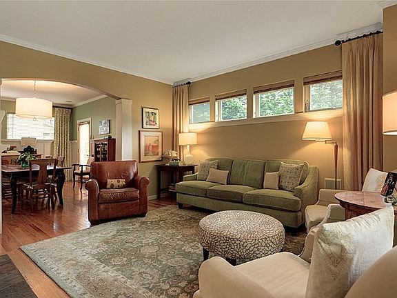 Large light filled formal living room with a gas fireplace.