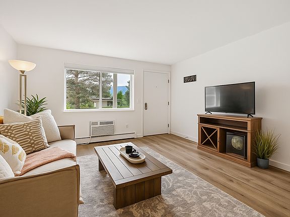 Soak in mountain views from this bright and welcoming living room _ a cozy retreat that feels both playful and peaceful the moment you arrive.