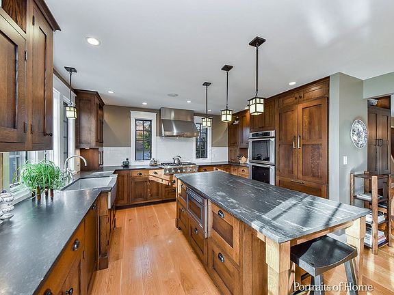 Custom Quarter-Sawn Oak Cabinetry with Lighted Accent Shelves; Cordoba Dolomite Countertops; Thermad