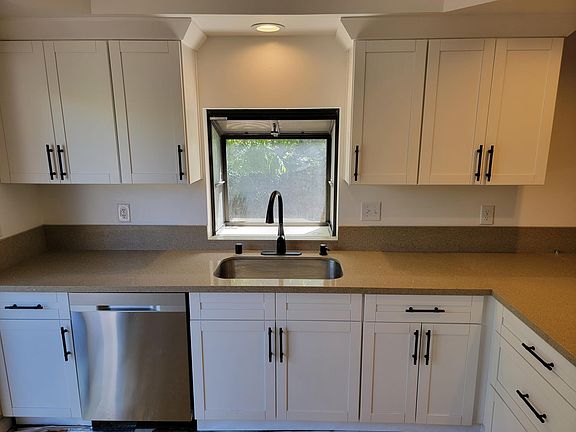 Such a great looking kitchen! Slider to back deck is on the left of photo and herb garden pop out window at sink.