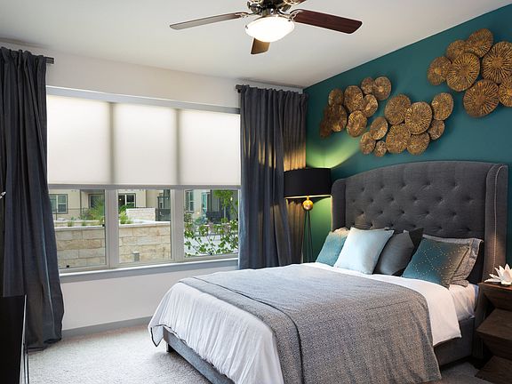 Spacious primary bedrooms with large windows and solar shades