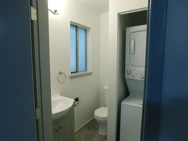 Second bedroom one-half bath with stack washer and dryer.