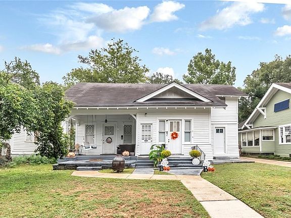 Bungalow-style house featuring a porch and a front lawn