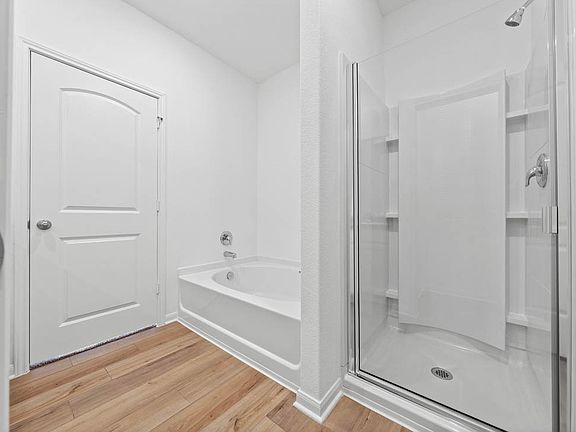 The master bathroom includes a tub and step-in shower.