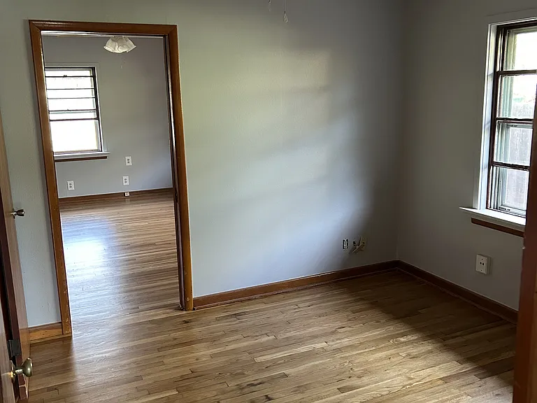 Master suite looking in from hallway. First room is classified as an office and back room is the bedroom with closets.