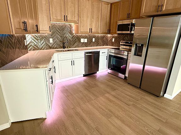 Kitchen has upper under cabinet lighting, and base cabinets with color change lighting capability