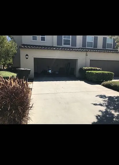 Large driveway with attached garage.