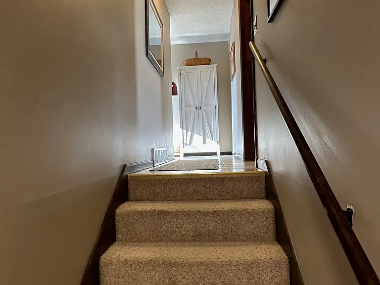 This is the stairway that leads out of the downstairs to the kitchen and next level.