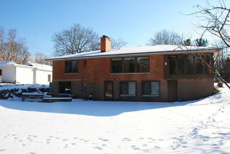 This is the back of the home. The door on the right is a utility shed for storing the lawn mower and other supplies. it is accessible from basement family room or a backyard doorway.